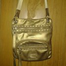 Tyler. Roda . Golden leather cross body handbag for women