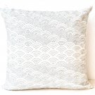 Ivory white throw pillows with detailed embroidered waves