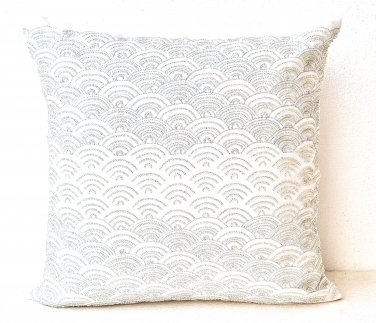 Ivory white throw pillows with detailed embroidered waves