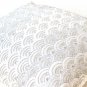 Ivory white throw pillows with detailed embroidered waves