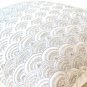 Ivory white throw pillows with detailed embroidered waves