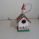 red white and blue wooden bird house