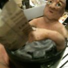 senior citizen man reading paper in a cup of coffee