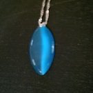 Deep blue elongated oval glass cats eye pendant on silver necklace