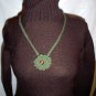 Hand crochet necklace in olive green with medium purple glass bead center