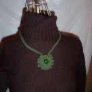 Hand crochet necklace in olive green with green glass bead center