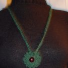 Hand crochet necklace in olive green with red glass bead center