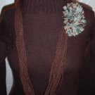 Handmade Infinity scarf/ necklace in a two tones of brown  with a large multi colored pom-pom