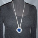 Hand crochet necklace for a cause in white with multicolor specs and blue center