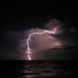 BEAUTIFUL LIGHTNING STRIKE OVER OCEAN COLOR PHOTO CLOUDS WAVES NATURES FORCE