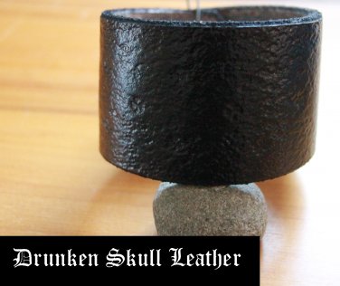 Wide black leather cuff with hand tooled background with shamrocks