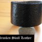 Wide black leather cuff with hand tooled background with shamrocks