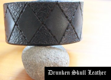 Dark green leather cuff with hand tooled argyle design