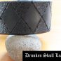 Dark green leather cuff with hand tooled argyle design