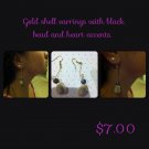 Gold Cowry Shell Earrings with Black Bead Accent.