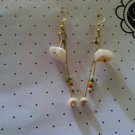 Chandelier style puka shell earrings with reggae bead accents.