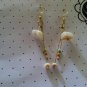 Chandelier style puka shell earrings with reggae bead accents.