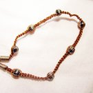AB12 - silver beads on a knotted bracelet