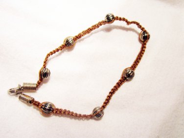 AB12 - silver beads on a knotted bracelet
