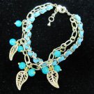 Gold chain with green leather bracelet