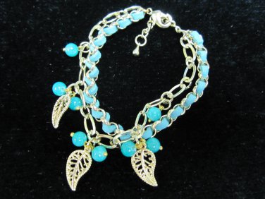 Gold chain with green leather bracelet