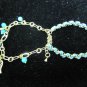 Gold chain with green leather bracelet