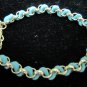 Gold chain with green leather bracelet