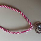 Bright pink and white kumihimo braid with a heart