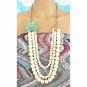 Matte cream faux pearl necklace with chunky antique gold chain and mint green beaded wired flower