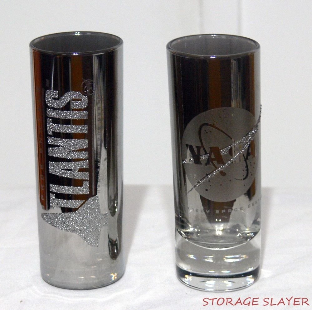 2 SMOKEY SILVER TALL SHOT GLASSES NASA SPACE SHUTTLE ATLANTIS SHOT GLASS