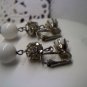 Vintage milk glass and rhinestone prong set orbs in silvertone clip earrings