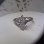 Silvertone ring marked NR with crystal sparkler in size 8-9
