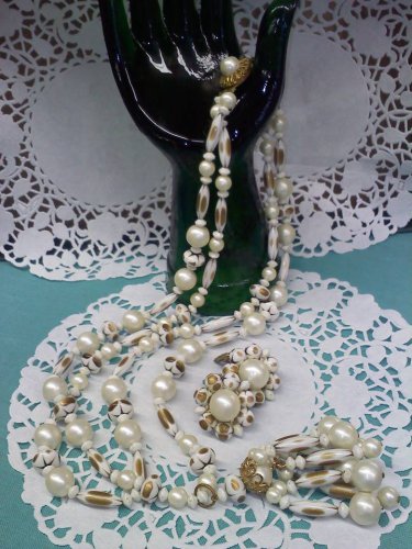 Faux pearl, faux gold and a brass filigree topped tassel necklace with clip earrings