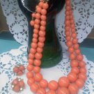 Coro - bright, coral, melon colored graduated bead necklace with screw back earrings