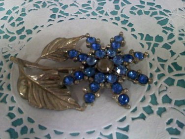 Blue rhinestones brooch pin on silvertone with gold highlights metal flower