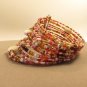 Handmade Indonesian Tribal Seed Bead Bracelet Cuff adorned shell, stone chips, and glass beads.