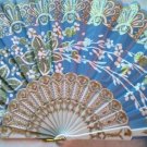 Folding Fan, Sky Blue silk with gold and white floral sprayby "Silk Breeze"