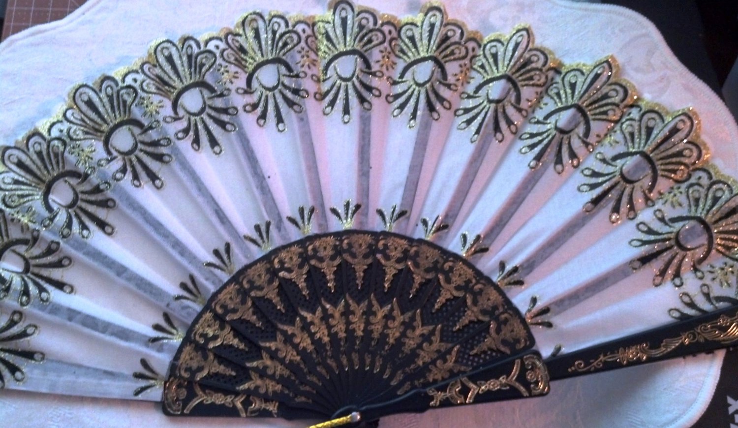 Folding Fan, light gray silk with gold glitter and black sunburst design by "Silk Breeze"