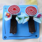 blue and red lollipop hair clips