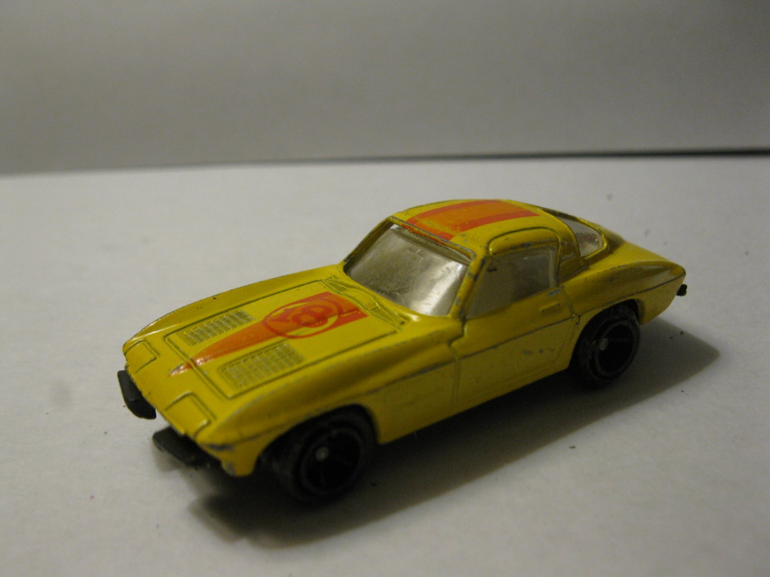 vintage Diecast car: Corvette Sting Ray Yellow w/ red & Orange stripes #18