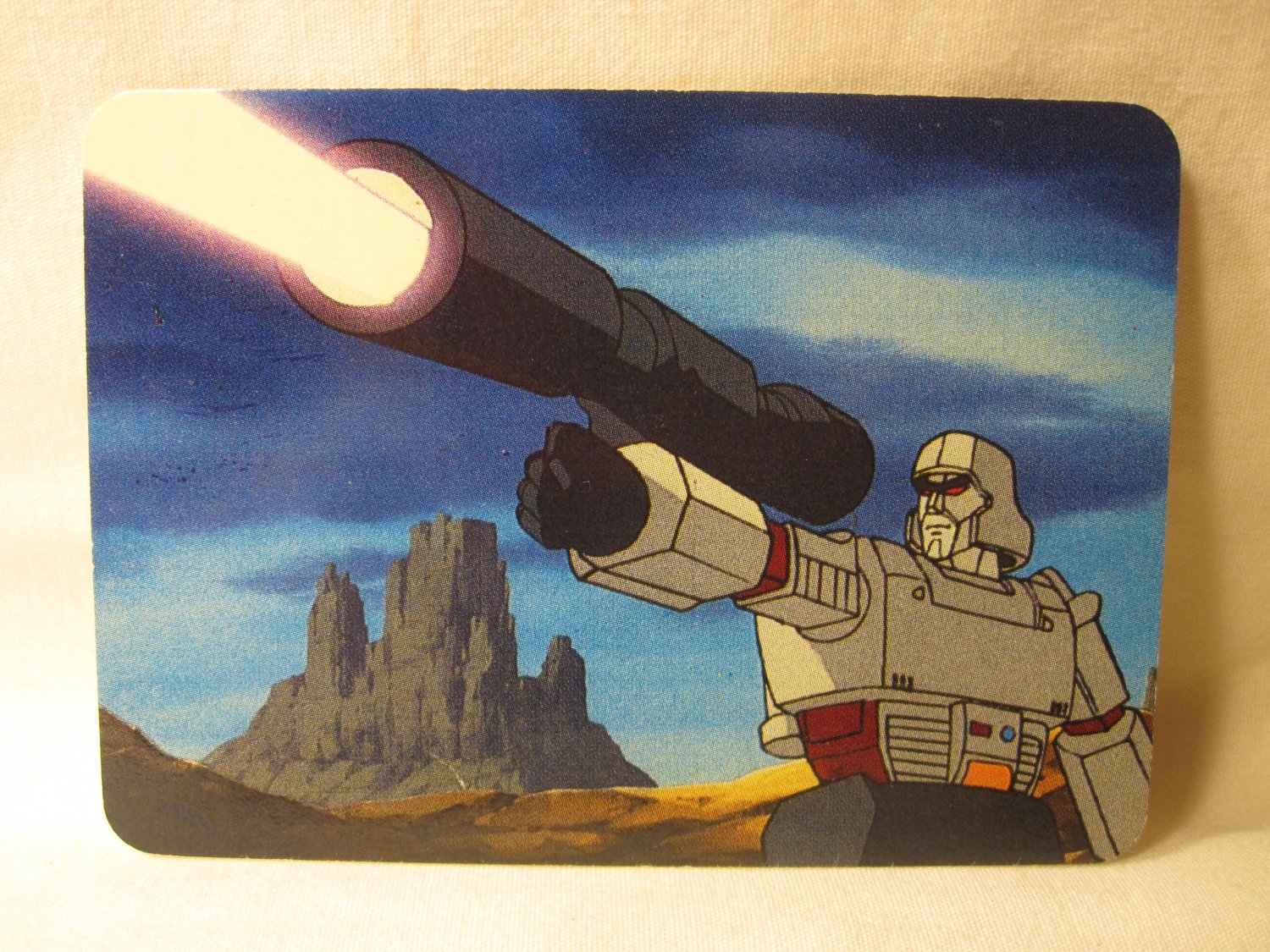 1985 Transformers Action trading card #140: A Megatron Blast