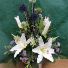 Tall artificial mixed flower and foliage table posy.