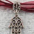 Silver Hansa Hand Charm on a Dark Red Ribbon Necklace