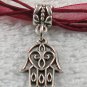 Silver Hansa Hand Charm on a Dark Red Ribbon Necklace