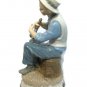 Narco Man Playing Horn Sitting on A Rock Figurine Statue Blue