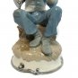 Narco Man Playing Horn Sitting on A Rock Figurine Statue Blue