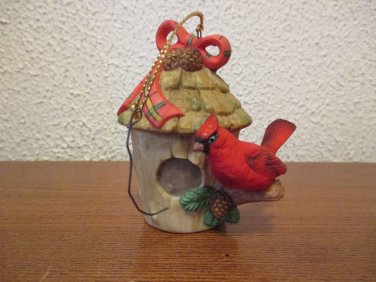 Cardinal perched on a birdhouse Christmas Ornament