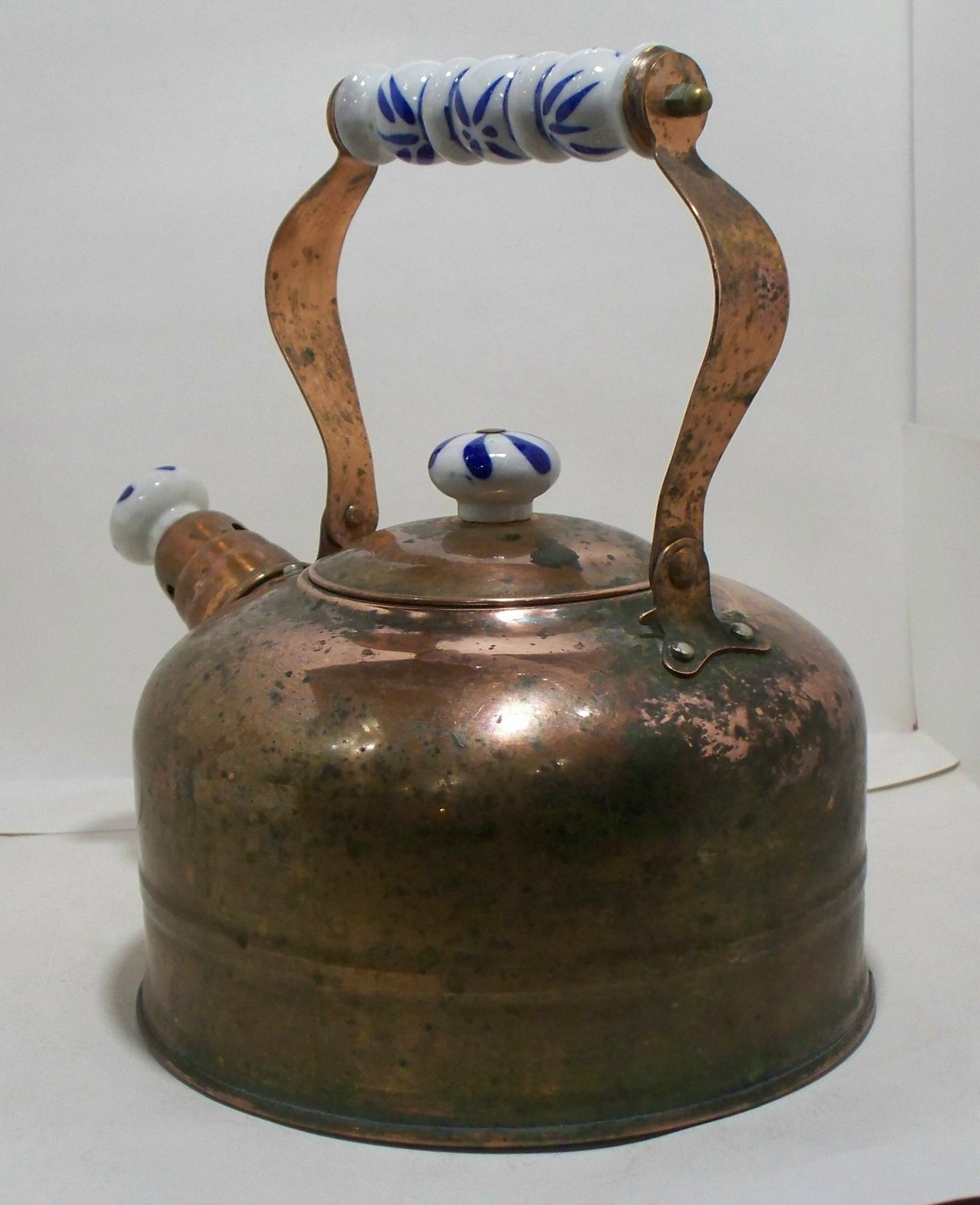 Brass or Copper maybe a combination with Porcelain handle & spout Tea