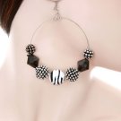 1 pair of medium hoop earrings with black, silver and zebra print beads