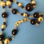 VINTAGE 24"  "NAPIER" BLACK & GOLD TONE NECKLACE. LARGEST BEAD IS 1/2" DIAMETER